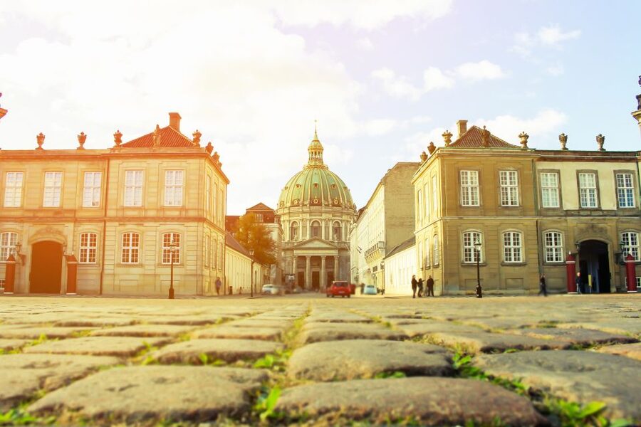 From Copenhagen: Private Frederiksborg Castle Tour - Crossing the castle lake and approaching the palace