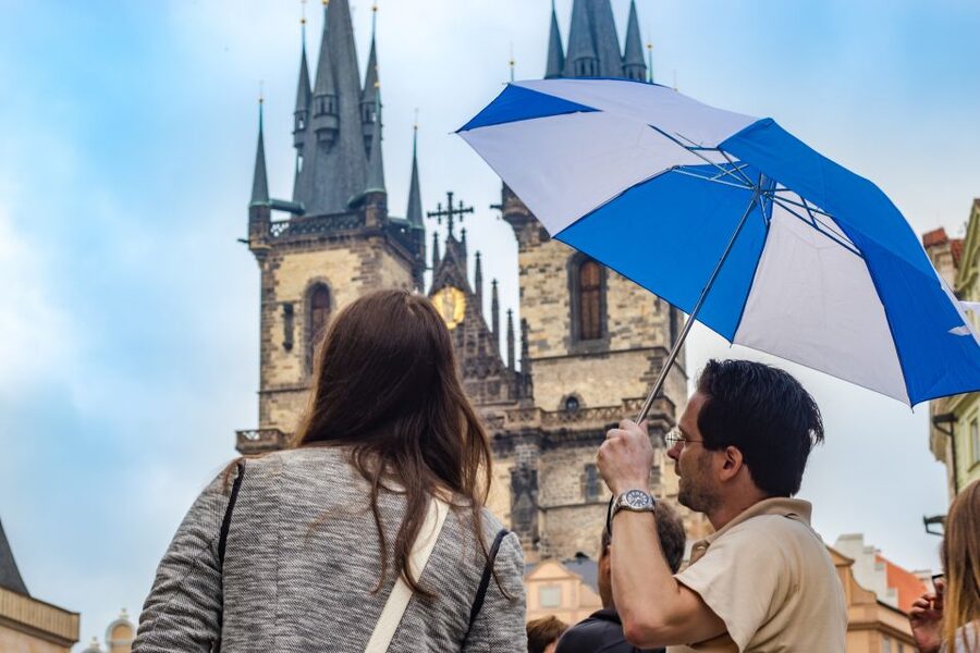 Prague: 3-Hour Walking Tour of Old Town & Prague Castle - Crossing Charles Bridge with the statues in view