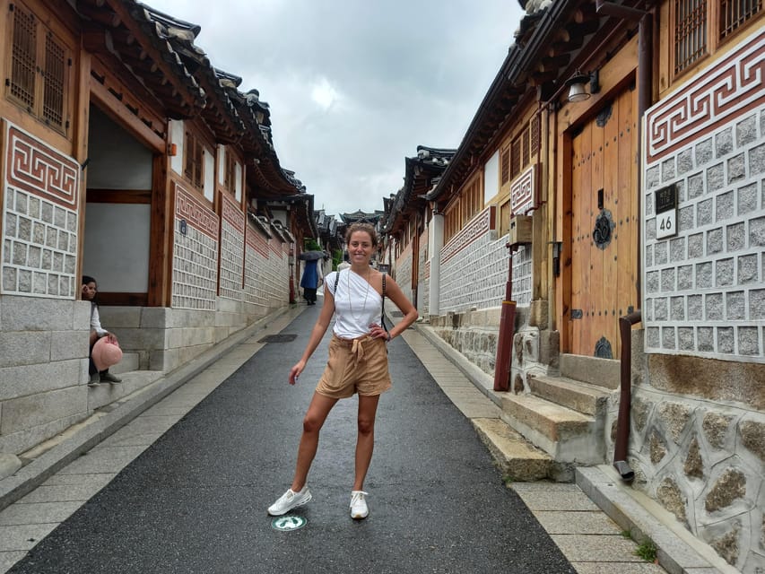 Seoul: 4-Hour Guided Tour to Palace, Bukchon, Jogyesa Temple - Bukchon Hanok Village: traditional homes with Seoul behind them